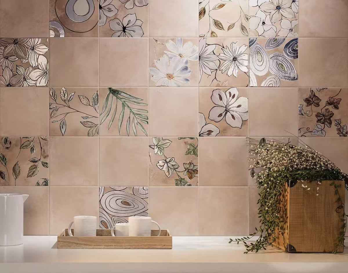 Pink Decorative tiles with floral and leaf patterns on a wall.