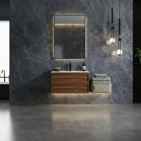 Bathroom with wooden vanity, mirror, and towels against a marble wall.