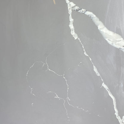 Calacatta grey engineered quartz stone benchtop slab — warm light grey base with bold flowing white marble veining, high gloss polished finish, 30mm custom cut vanity top