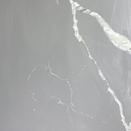 Calacatta grey engineered quartz stone benchtop slab — warm light grey base with bold flowing white marble veining, high gloss polished finish, 30mm custom cut vanity top