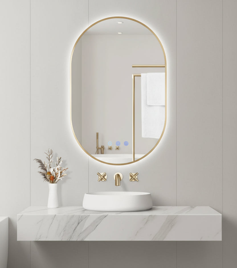 Bathroom setup with a round backlit mirror, sink, and decorative elements on a light gray wall.