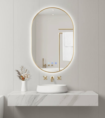 Bathroom setup with a round backlit mirror, sink, and decorative elements on a light gray wall.