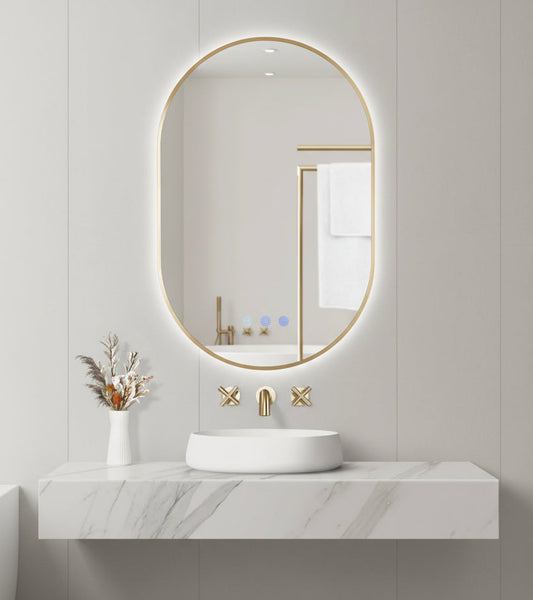 Bathroom setup with a round backlit mirror, sink, and decorative elements on a light gray wall.